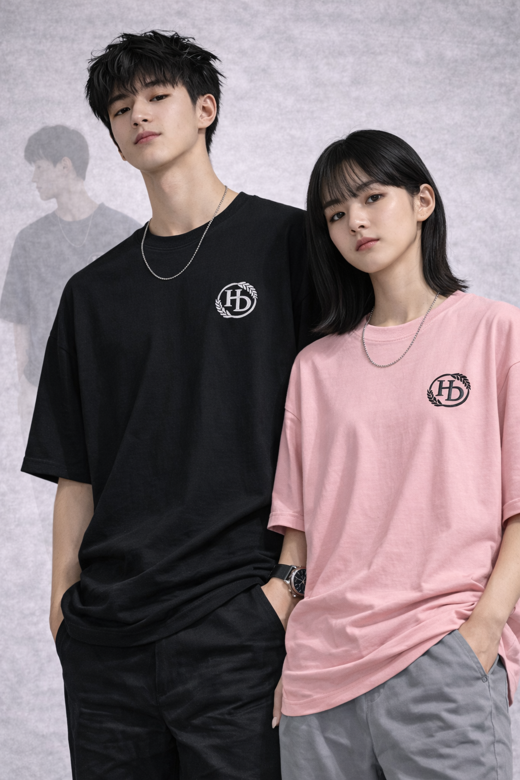 Male and female models wearing black and pink T-shirts with original HD silicone marks